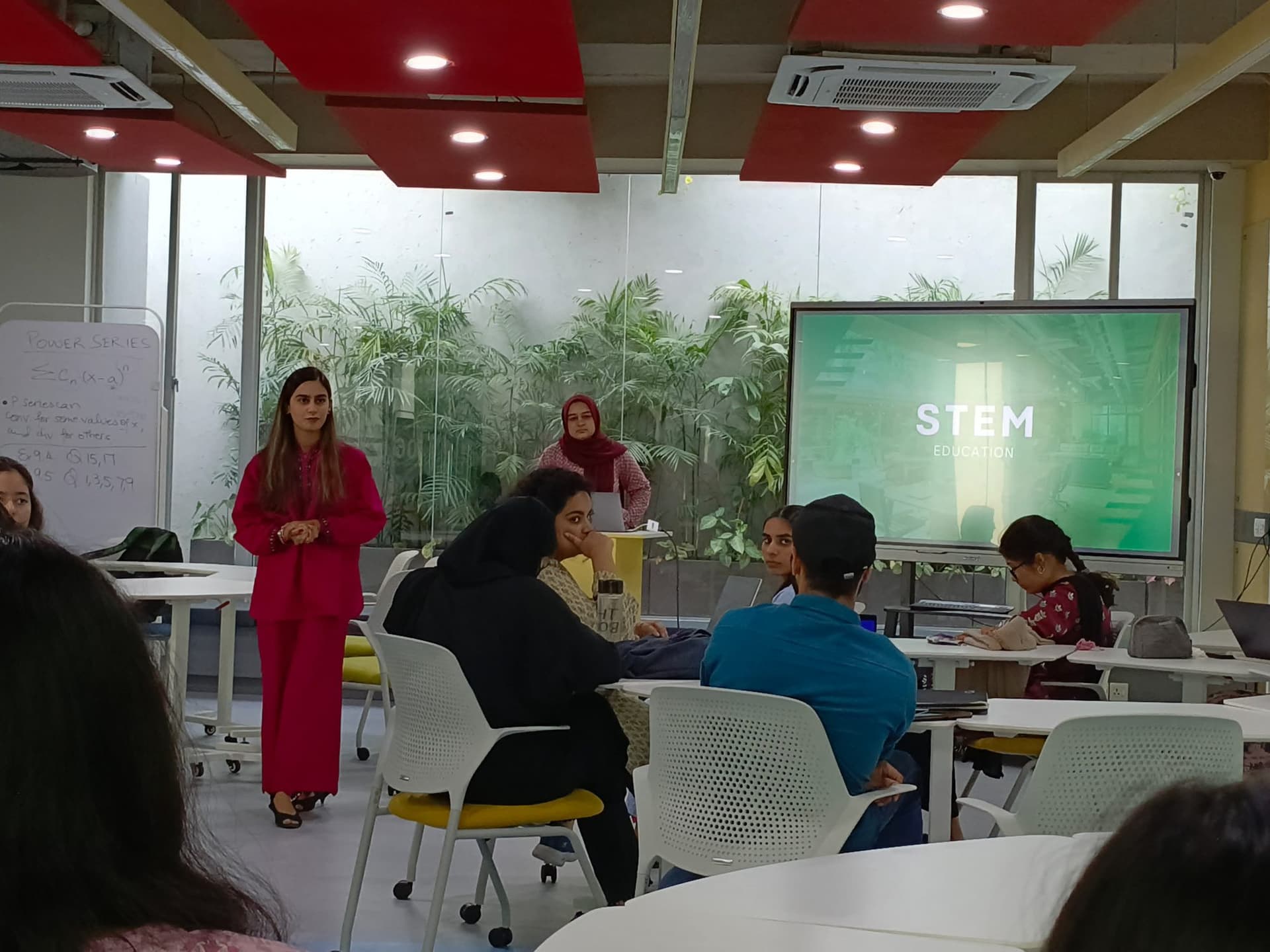 Lalain standing by a screen during an Environmental Leadership Forum session