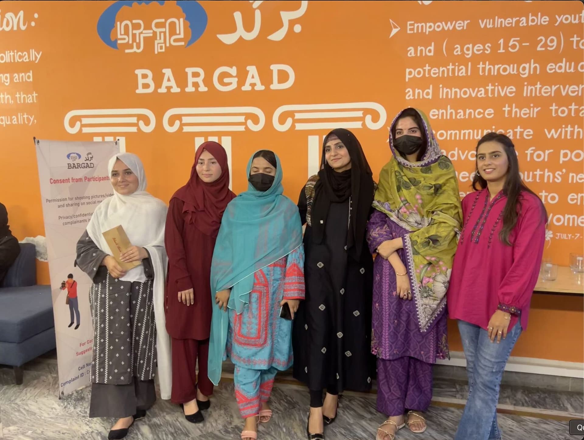 Lalain with other trainers in front of the orange Bargad wall