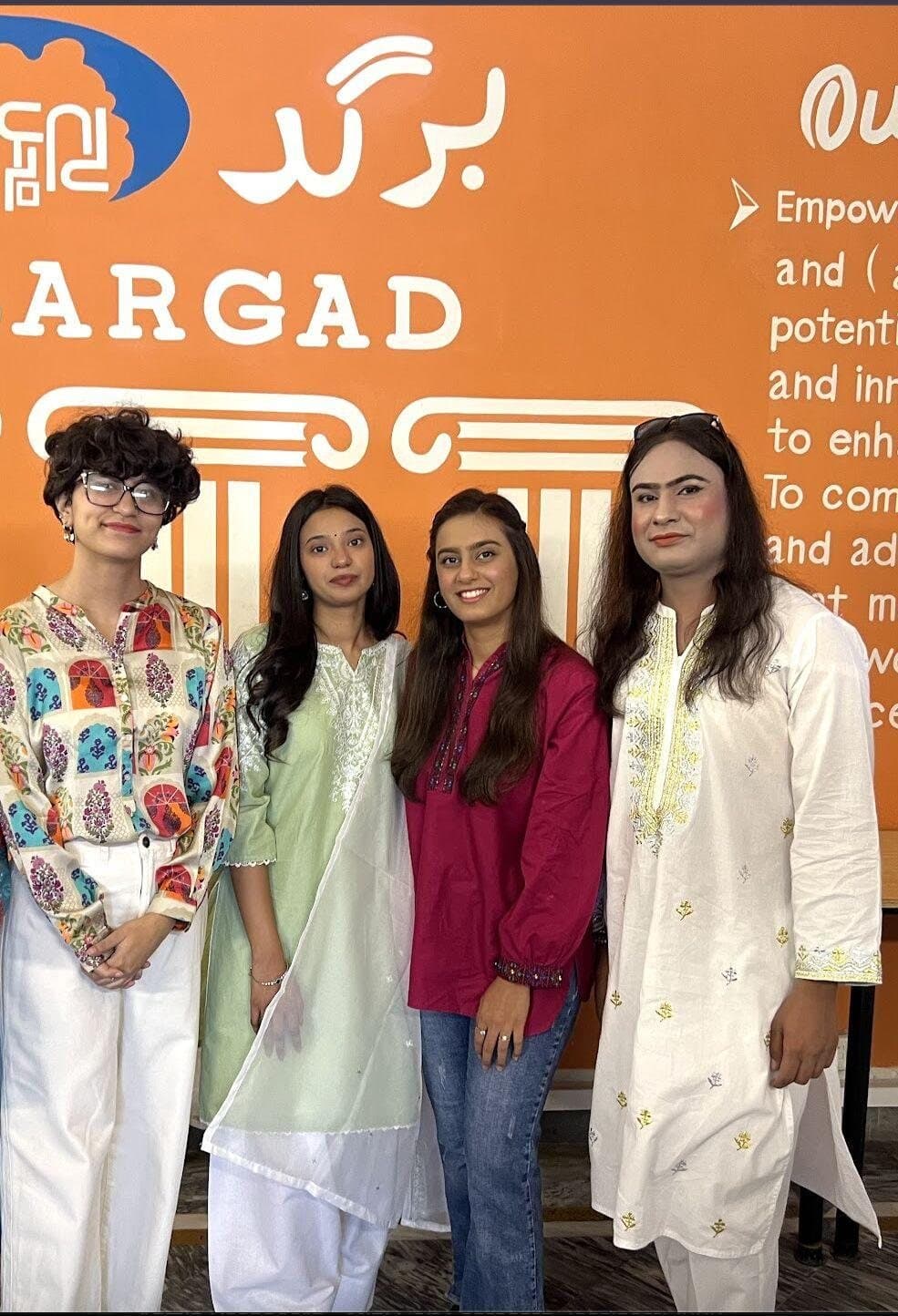 Lalain with fellow NYVN Master Trainers in front of the Bargad mission wall